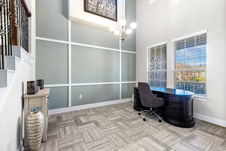 home foyer featuring a staircase, chandelier, and entryway desk