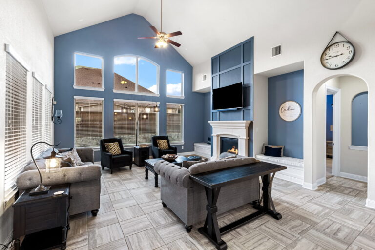 a stylish living room, with its dramatic blue accent wall and vaulted ceilings