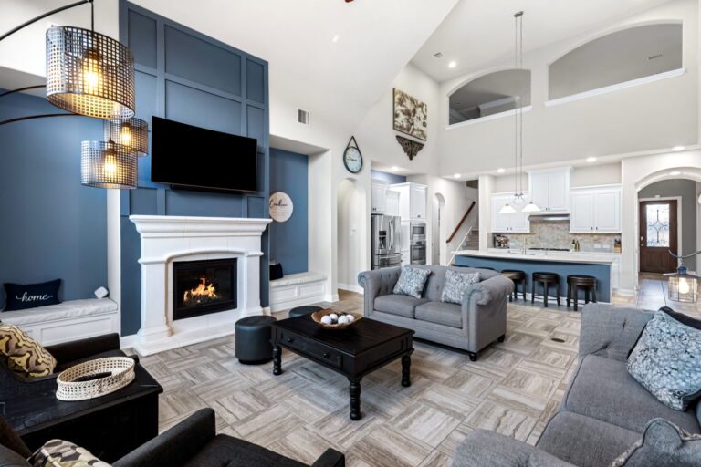 a stylish living room, with its dramatic blue accent wall and vaulted ceilings