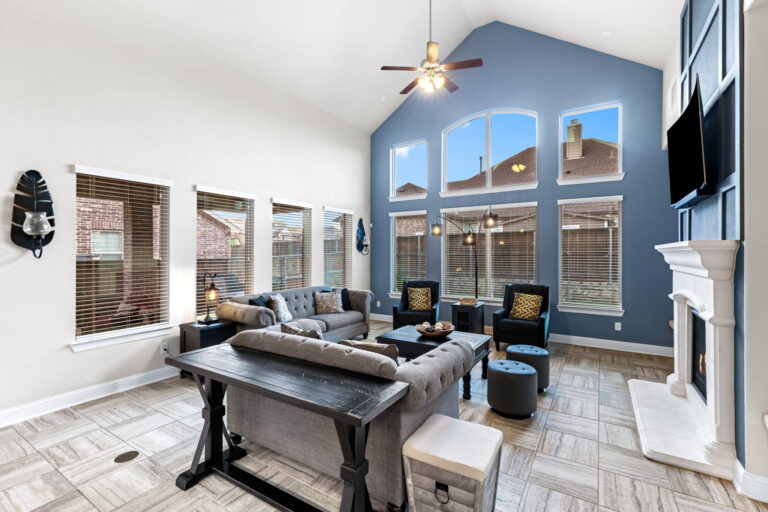 a stylish living room, with its dramatic blue accent wall and vaulted ceilings