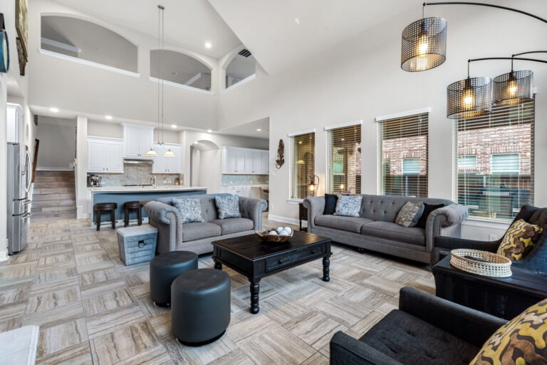 a stylish living room, with its dramatic blue accent wall and vaulted ceilings