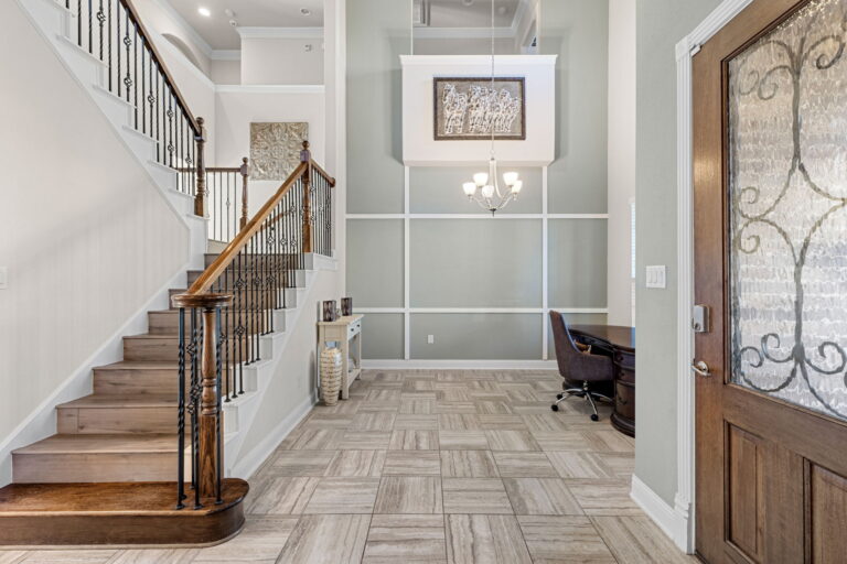 home foyer featuring a staircase, chandelier, and entryway desk